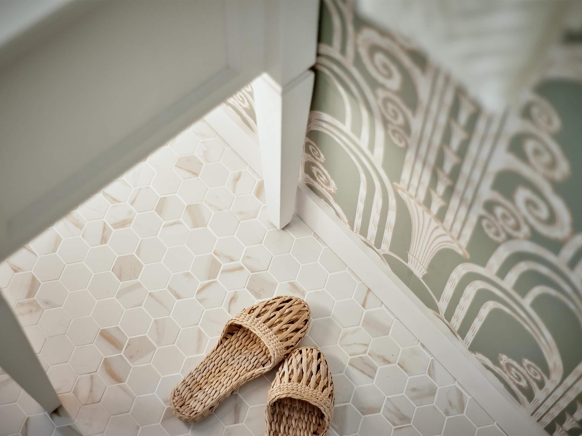 Close up of woven shoes by a lit side table