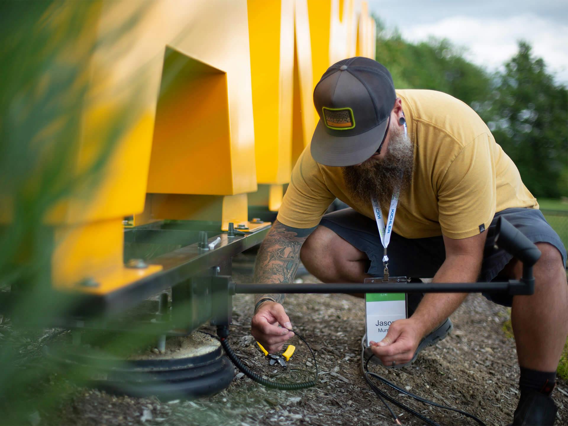 A man installing lights on the Akron Zoo sign