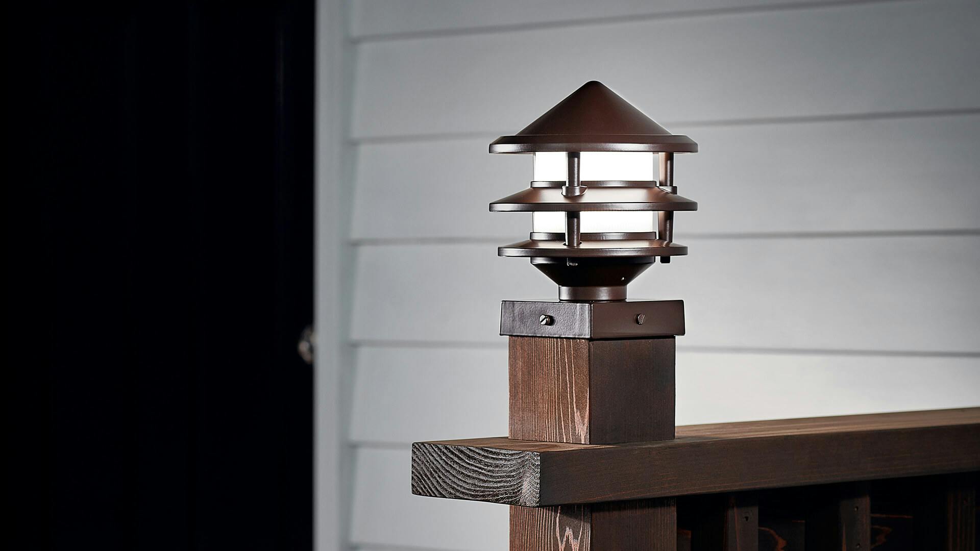 Close-up of a bronze post light on an outdoor deck