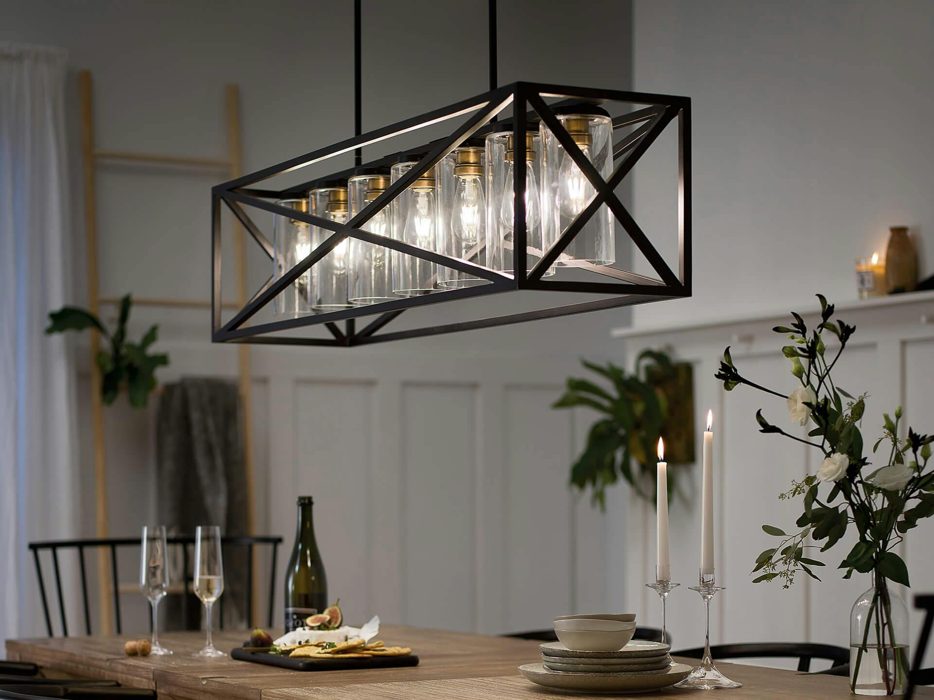 Dining room with long wooden table featuring a Moorgate chandelier