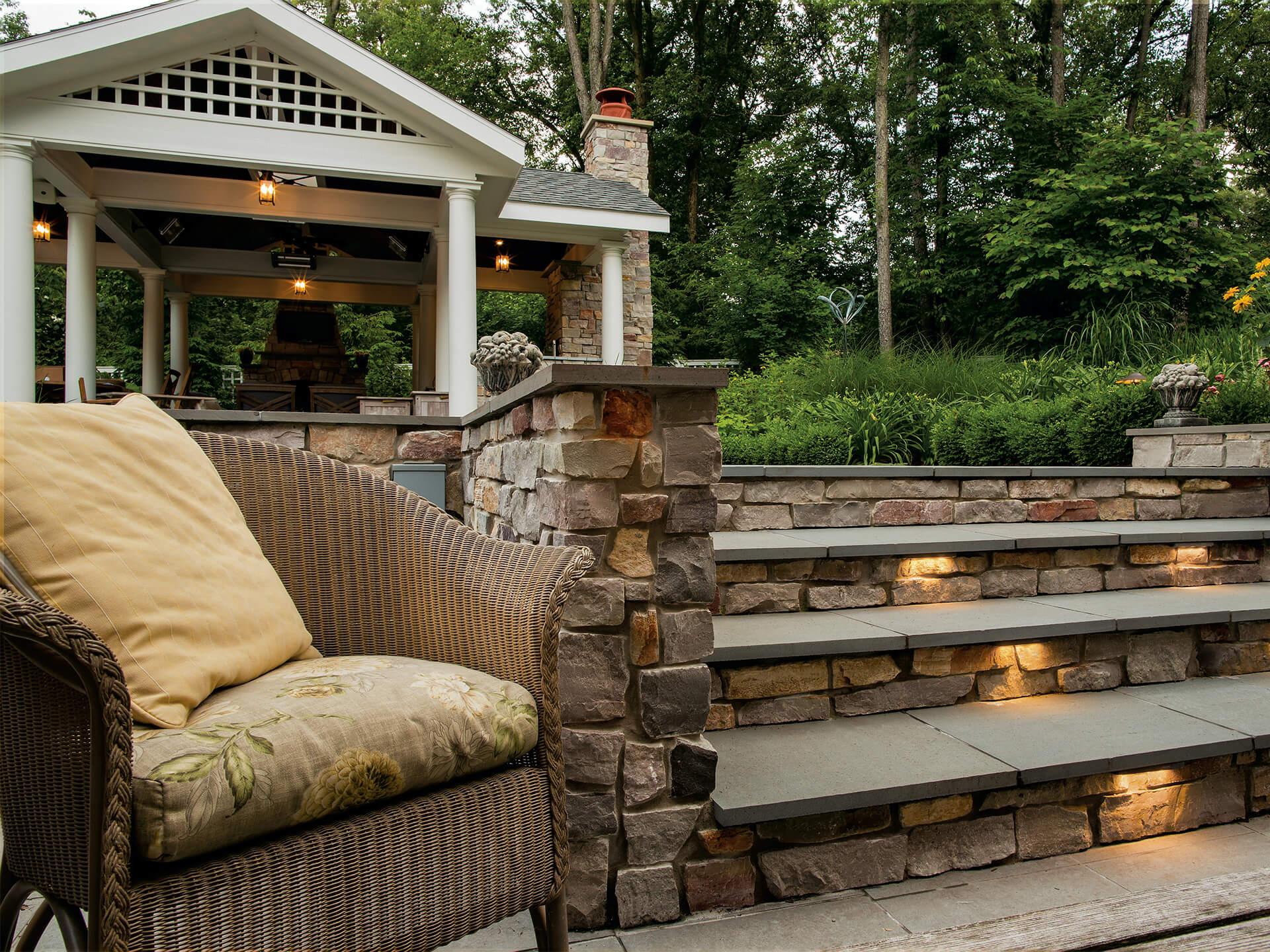 Daytime back yard with stone stairs and downlights on each step