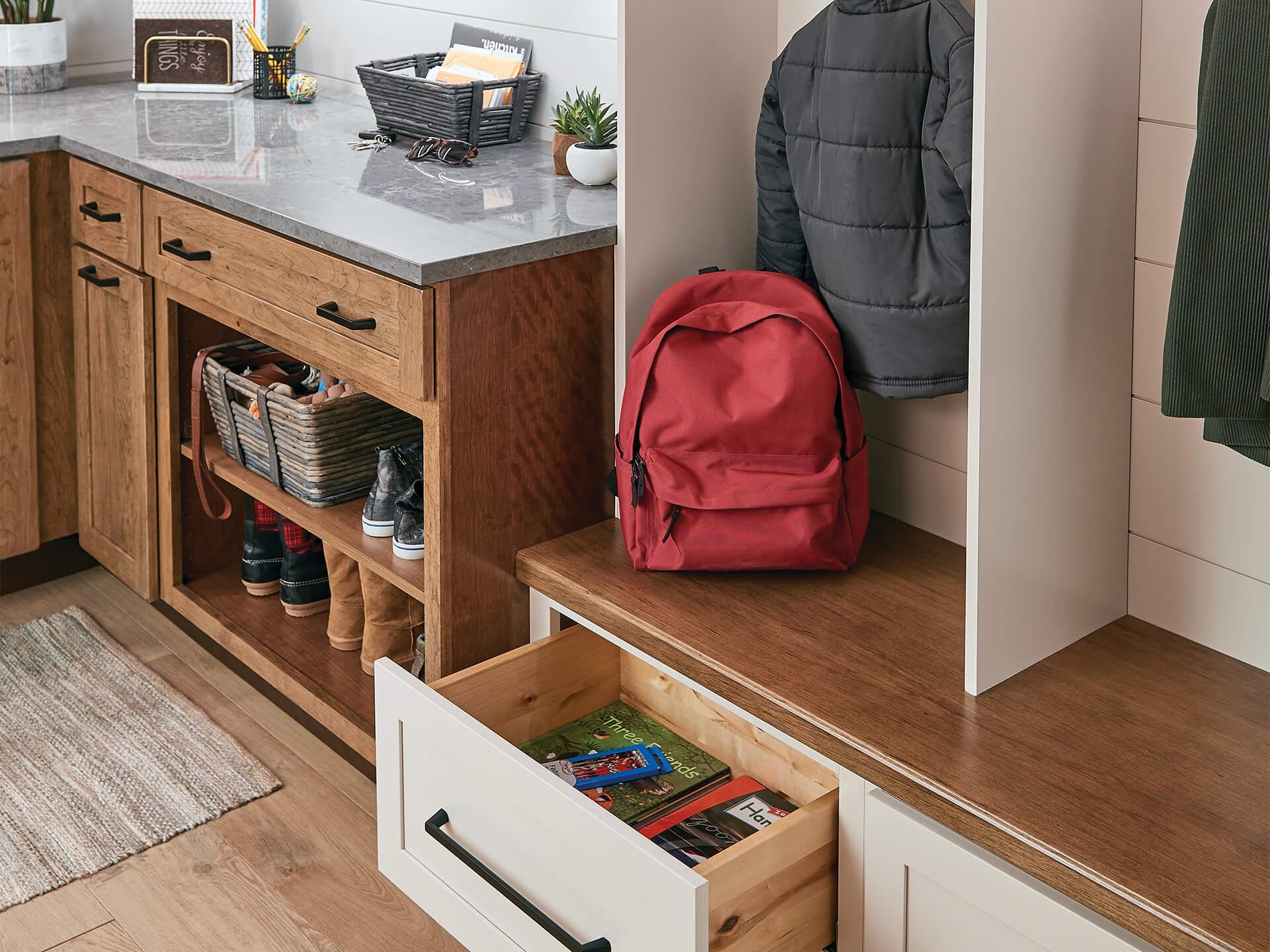 Corner of a mudroom with shelves and drawers containing miscellaneous apparel