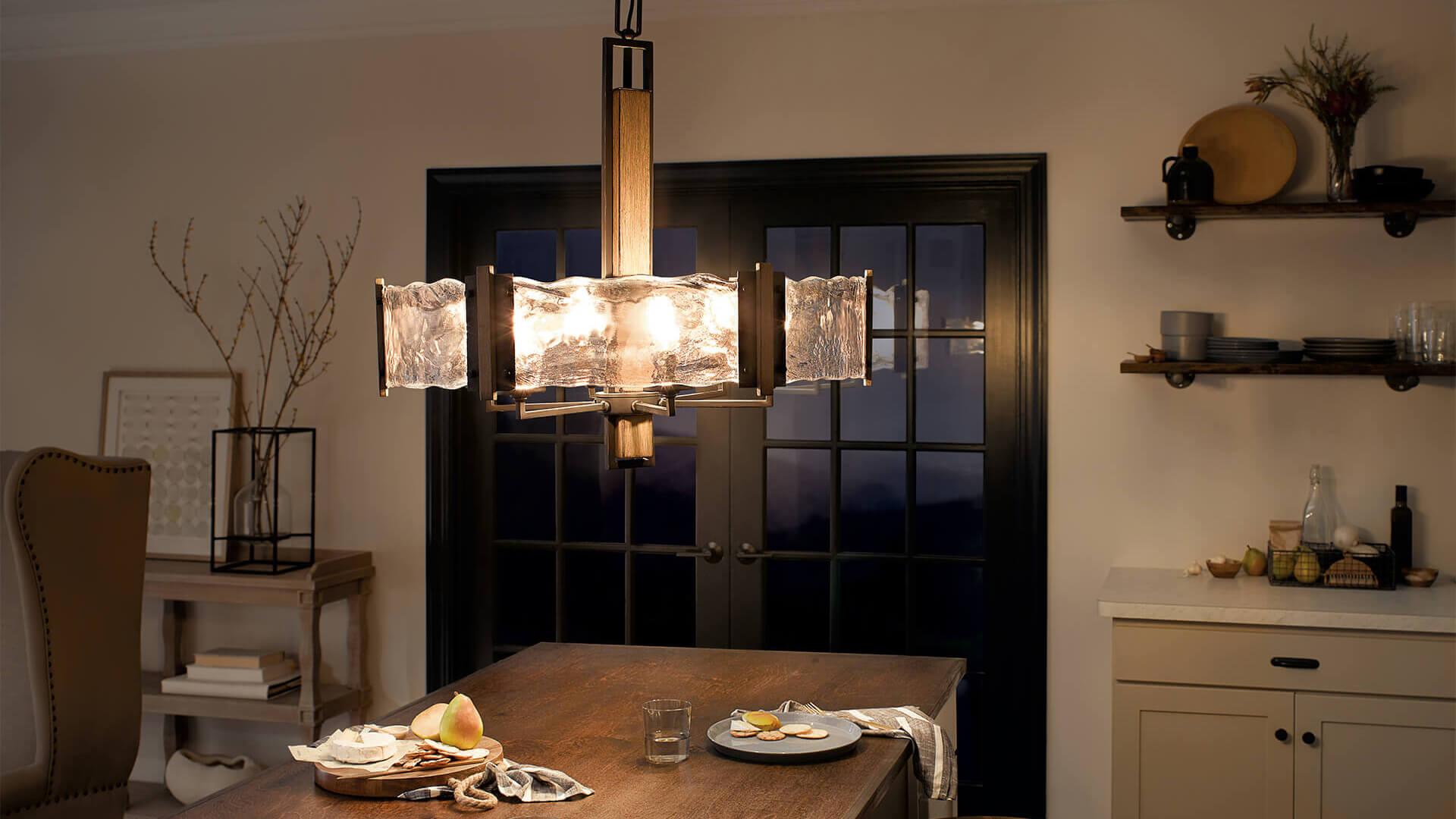 Living room at night with an Aberdeen chandelier hanging above the dining table