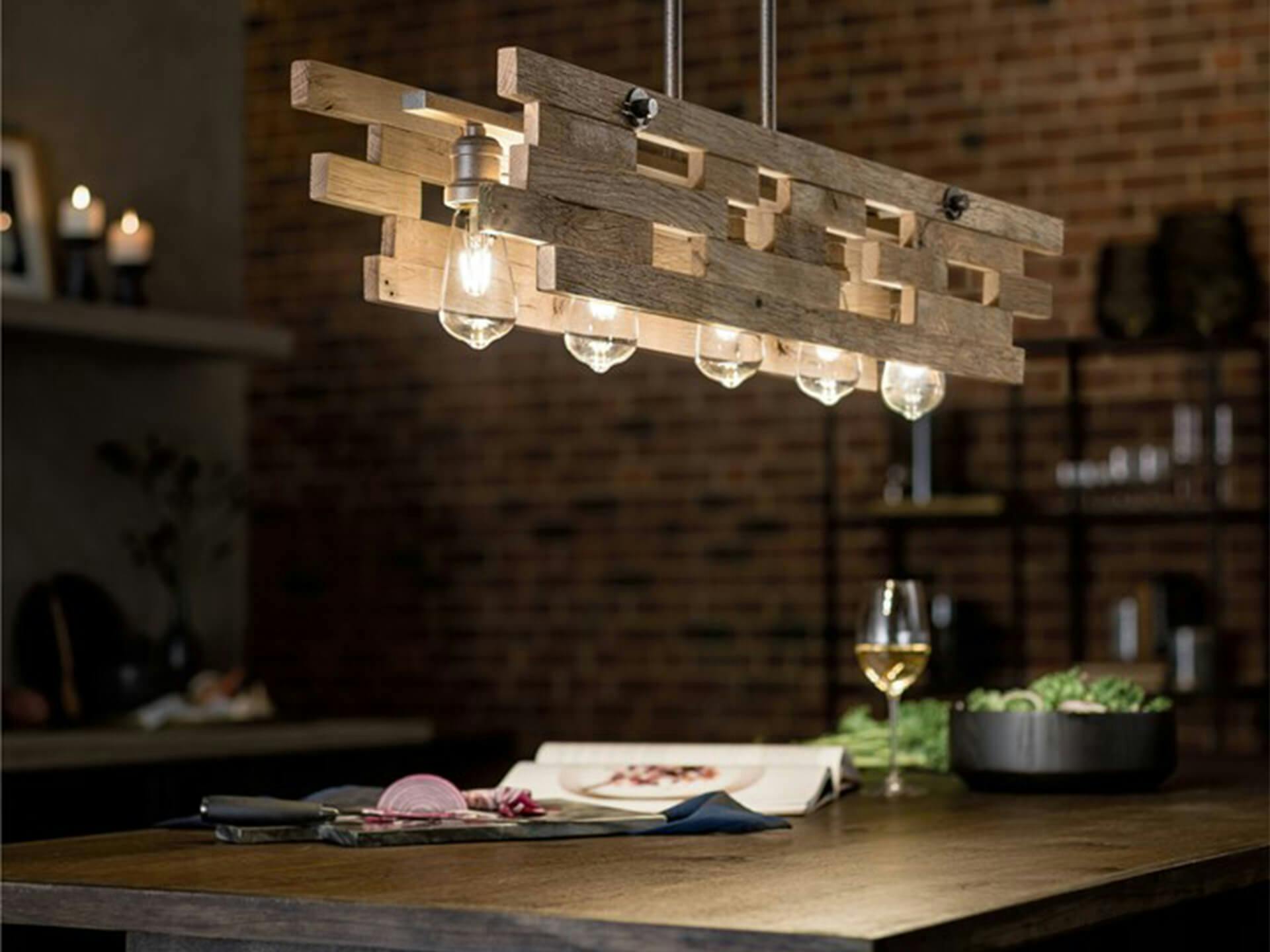 Industrial style dining room and kitchen featuring a Cuyahoga Mill chandelier