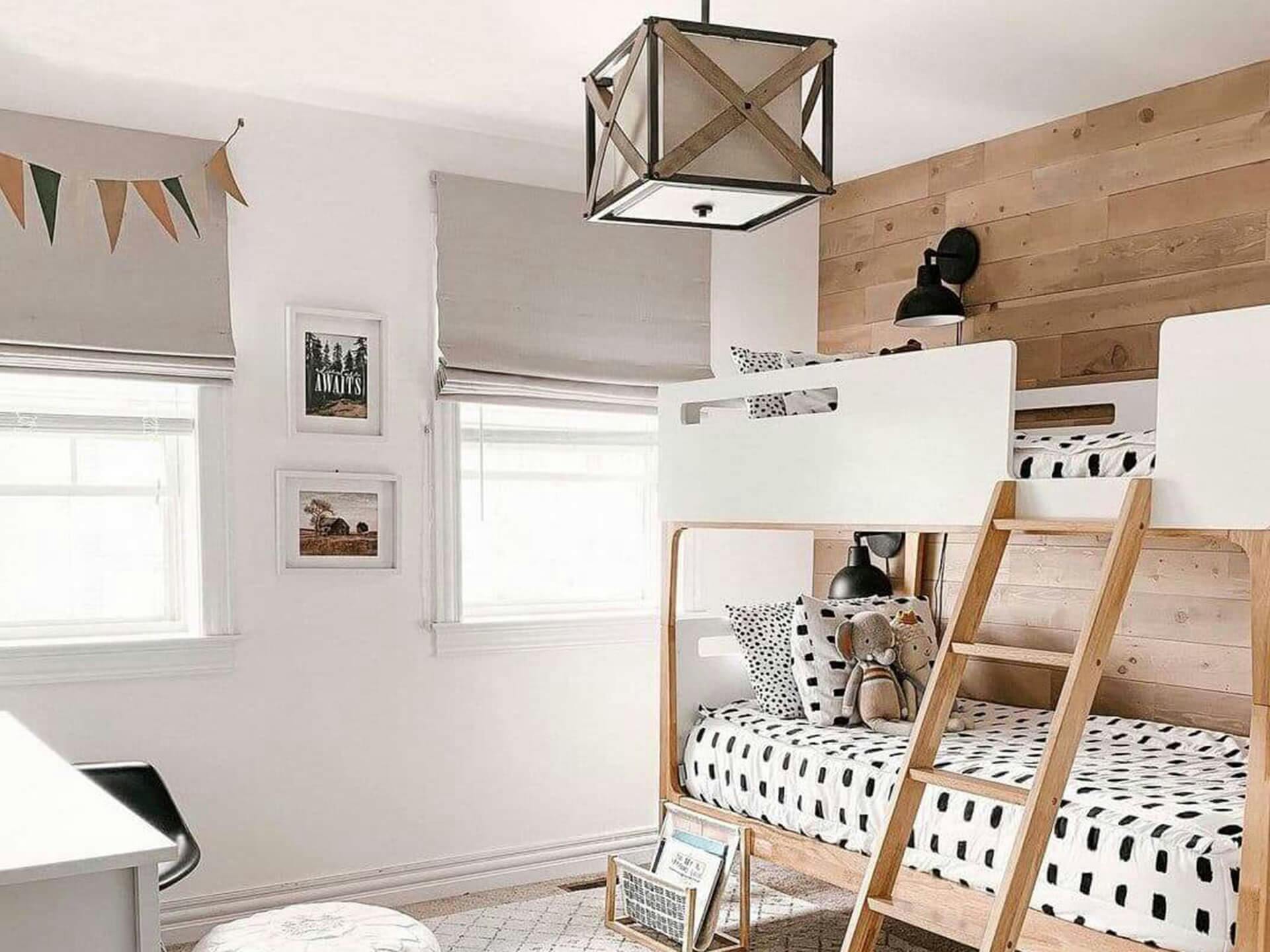 Bedroom with two open windows shining with daylight featuring a Cahoon hanging near the bunkbed