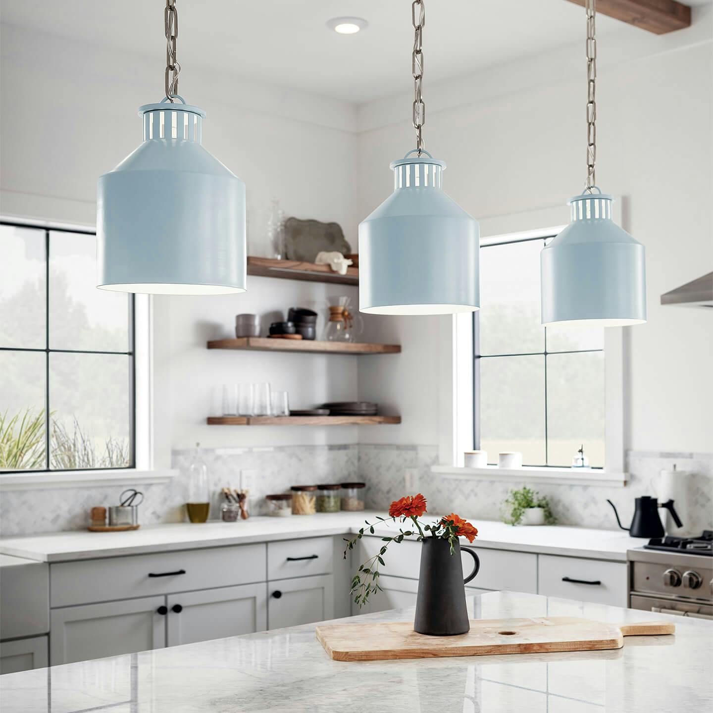 Light blue 3-light Montauk Pendants over kitchen island.