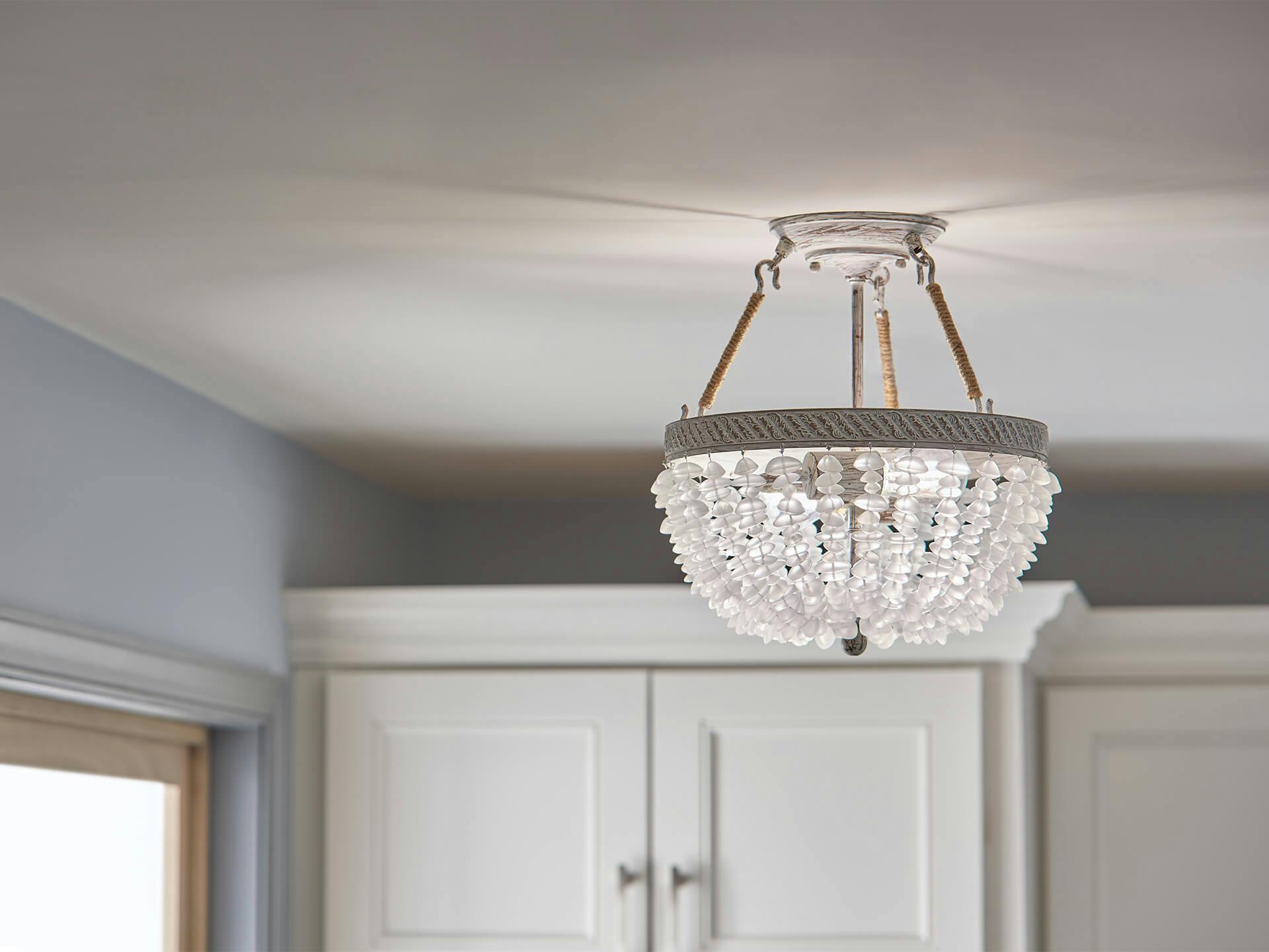 A close up detail shot of the Kona Cay Chandelier in the laundry room