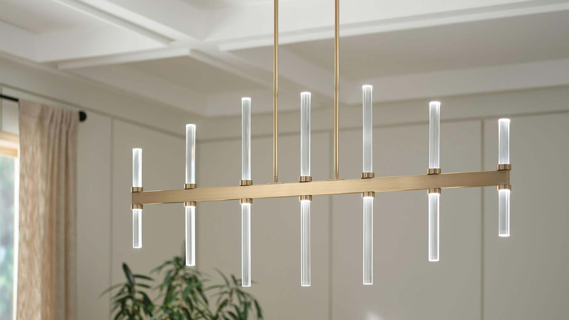 White dining room with focus on Sycara 14-light LED chandelier in champagne bronze