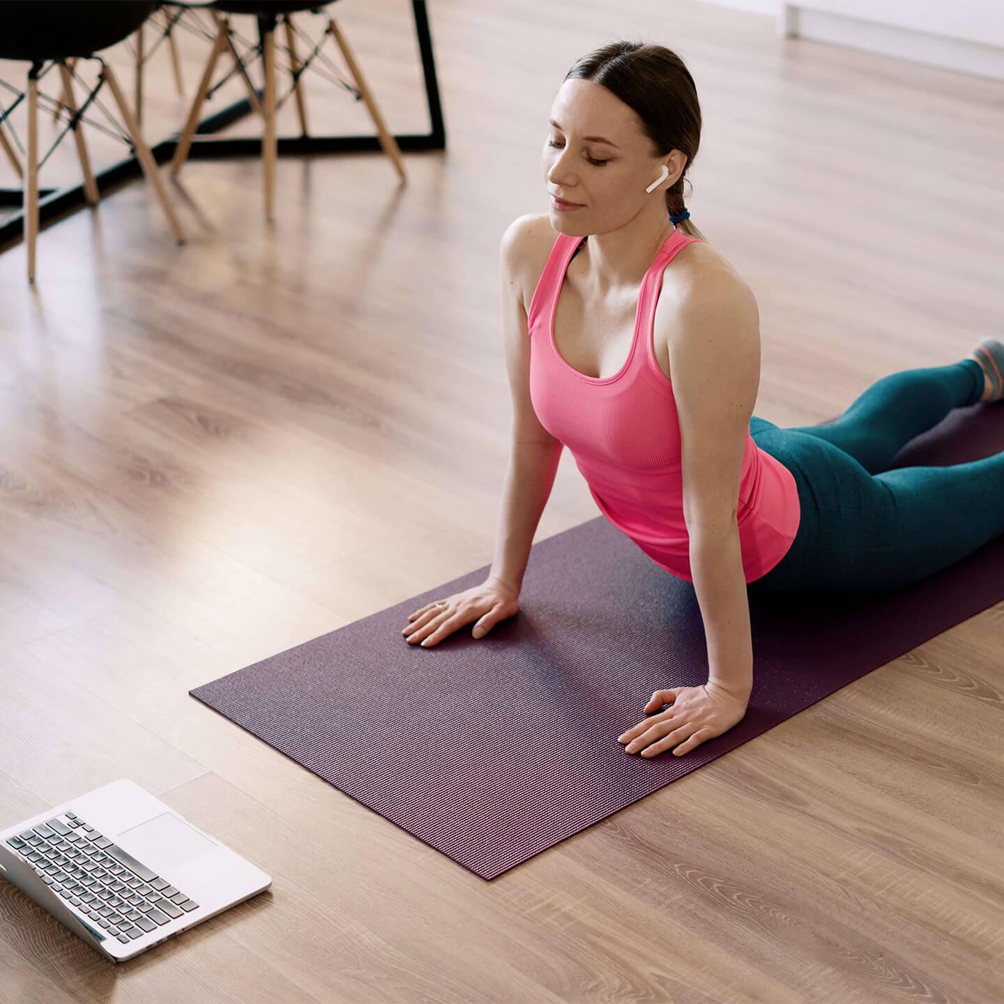 Woman in a yoga post on a purple mat