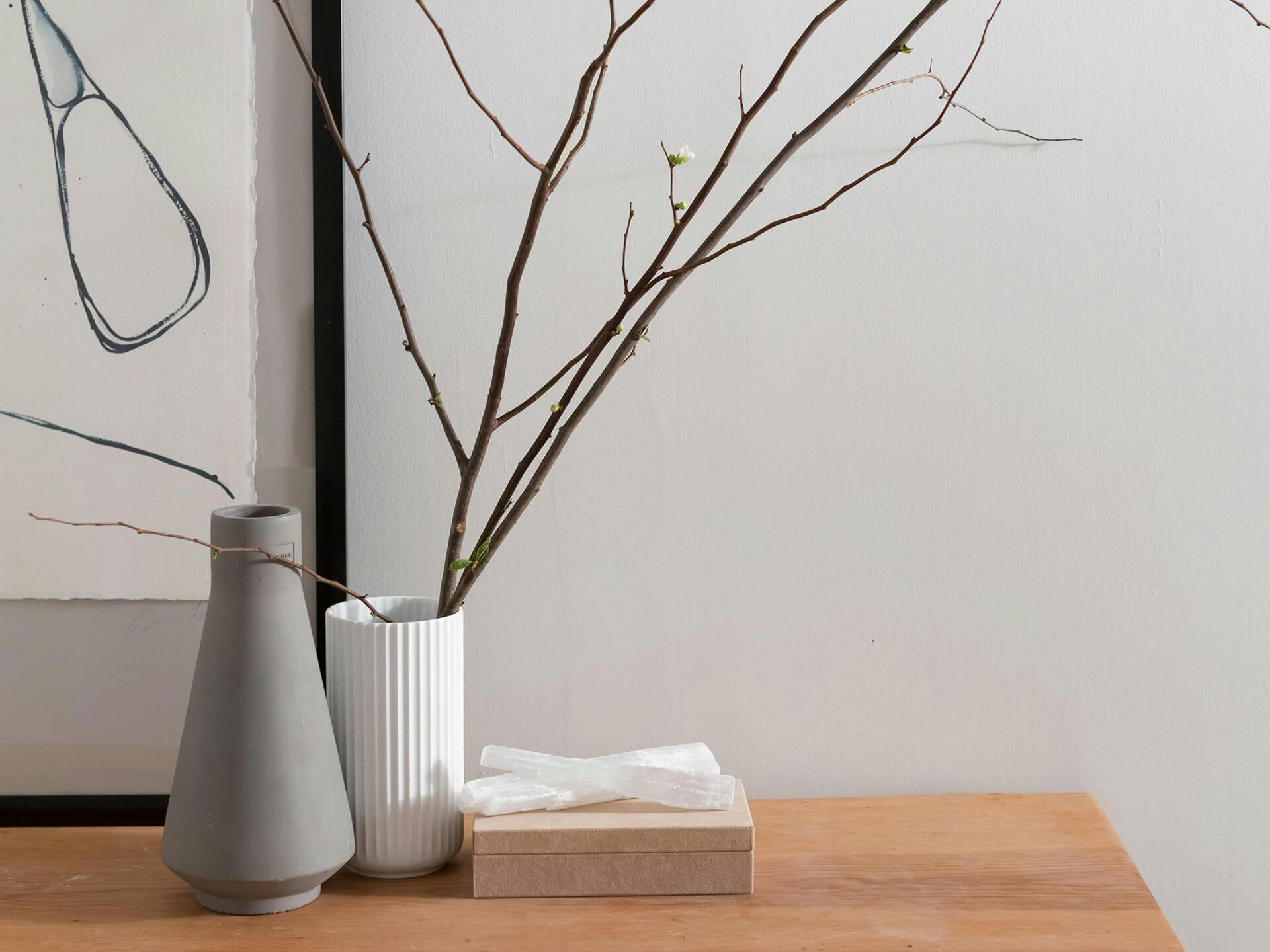 Vases on a table with branches 