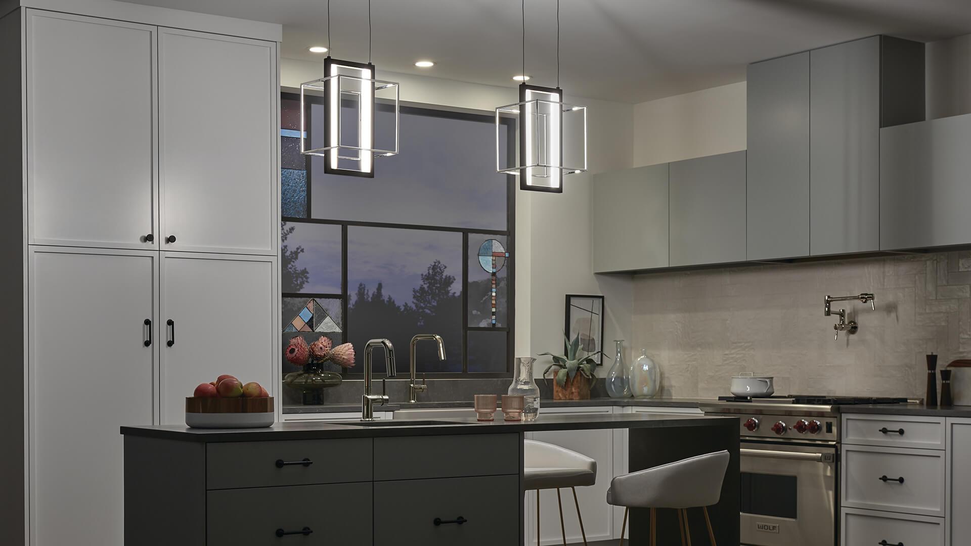 Modern kitchen at night with two Viho pendant lights hanging above a kitchen island