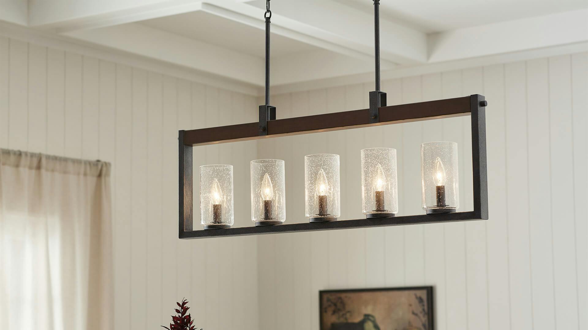 White dining room with wooden ceing and Barrington 5-light chandelier in distressed black finish