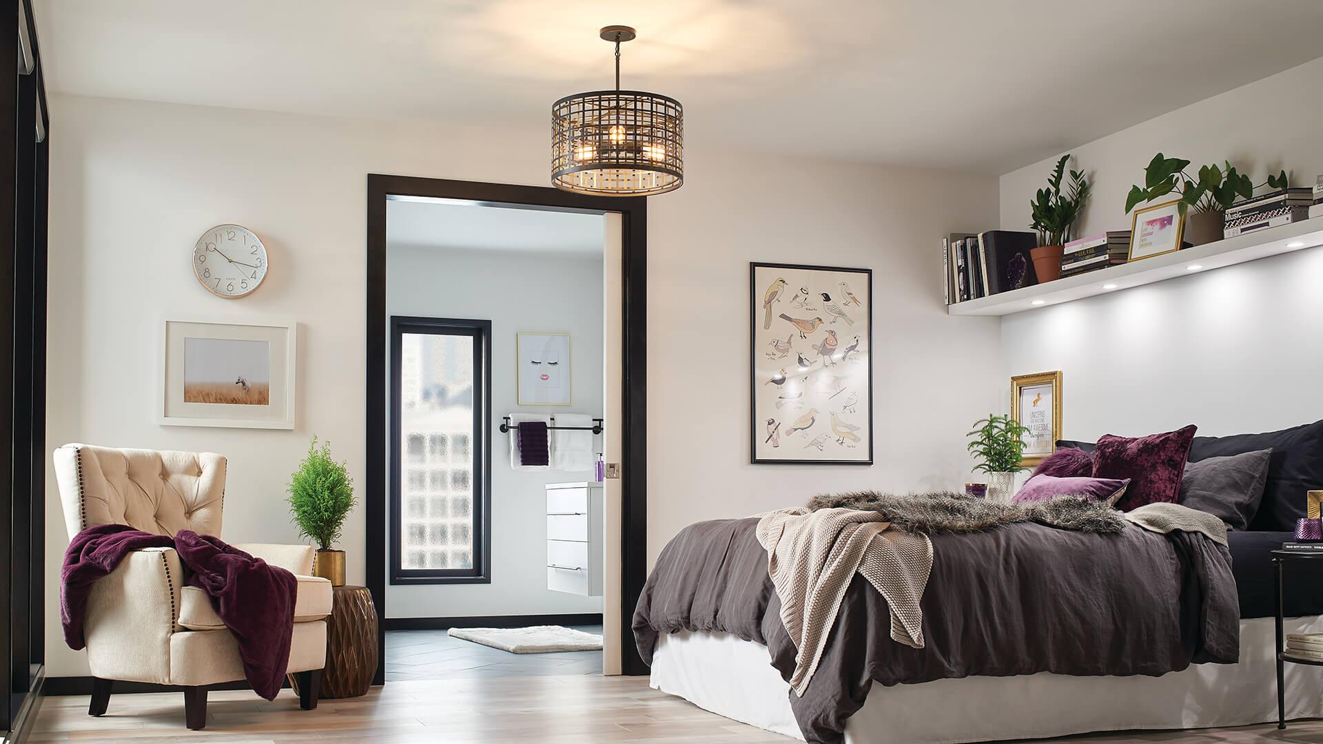 Bedroom at daytime with a Aldergate chandelier glowing in the middle of the room and lighting under a shelf over the bed