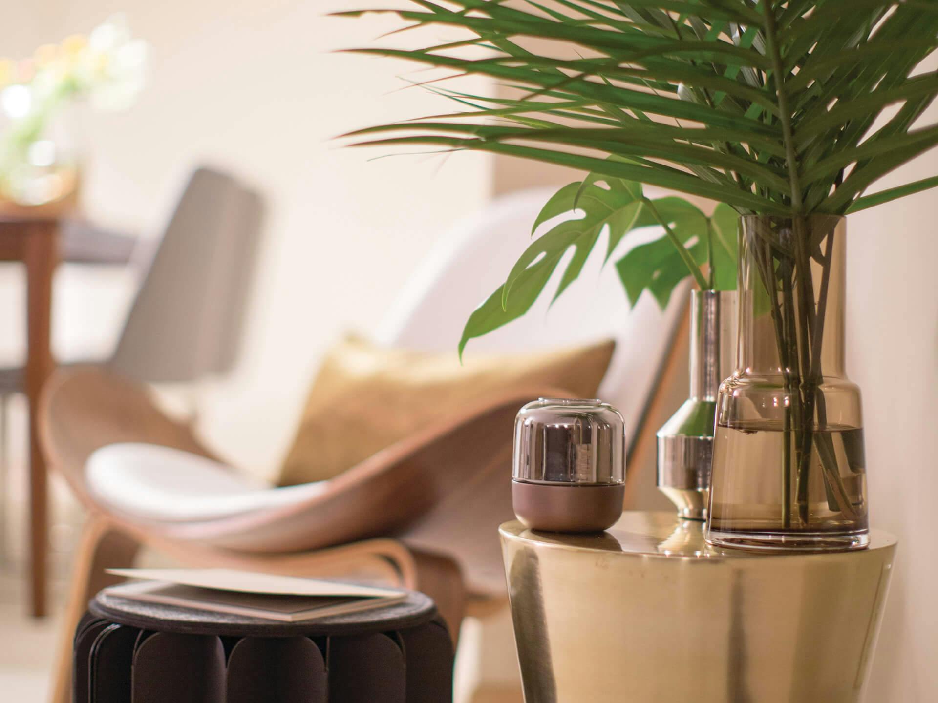 Close up picture of side table with vases and chair