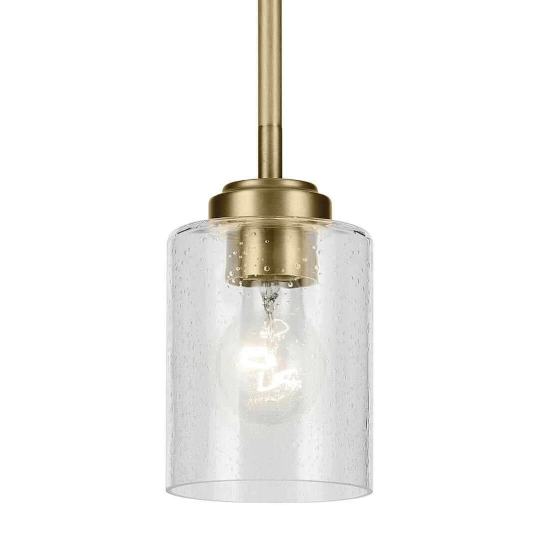 The Winslow 7.5" 1-Light Mini Pendant Light with Clear Seeded Glass in Natural Brass on a white background