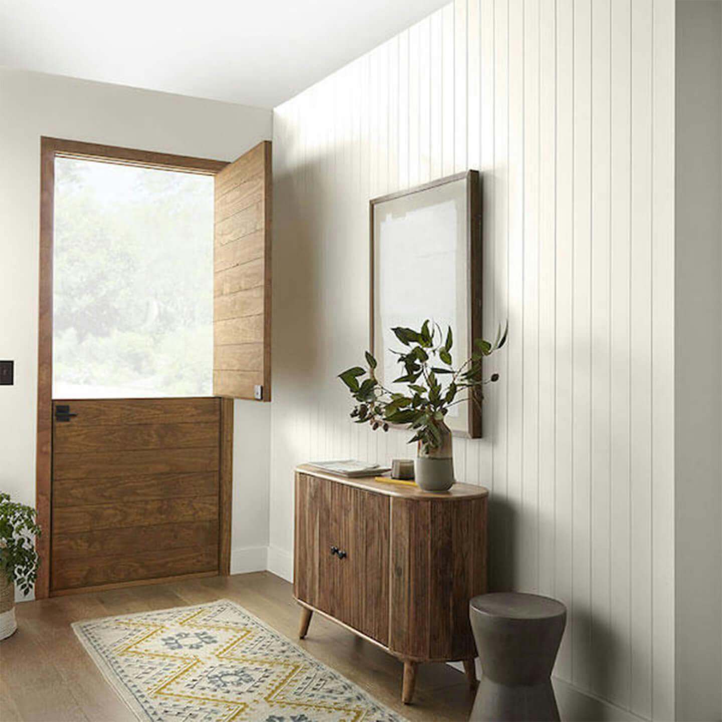 Entryway with open door, entry table and mirror.