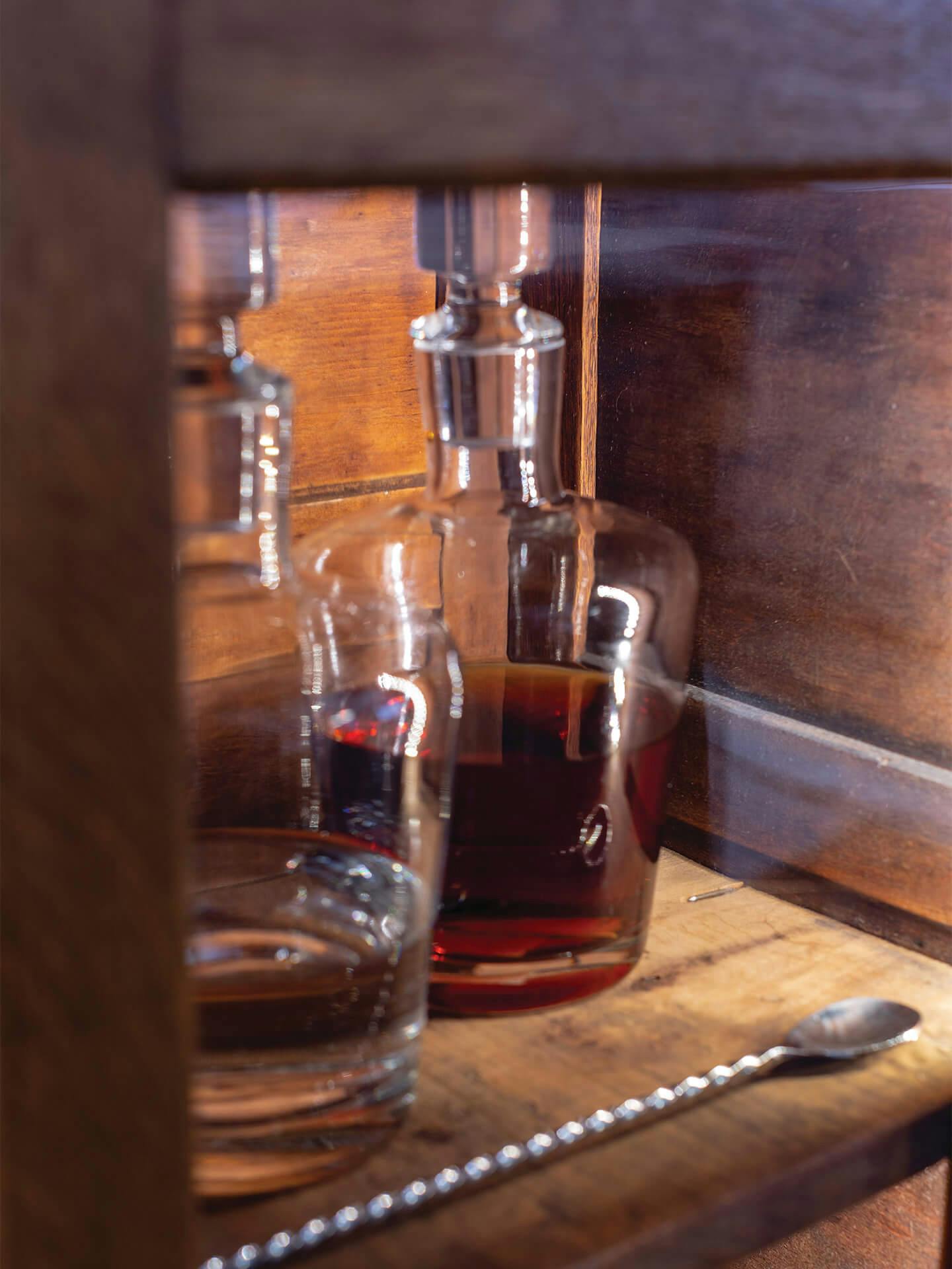 Two whiskey bottles on a shelf