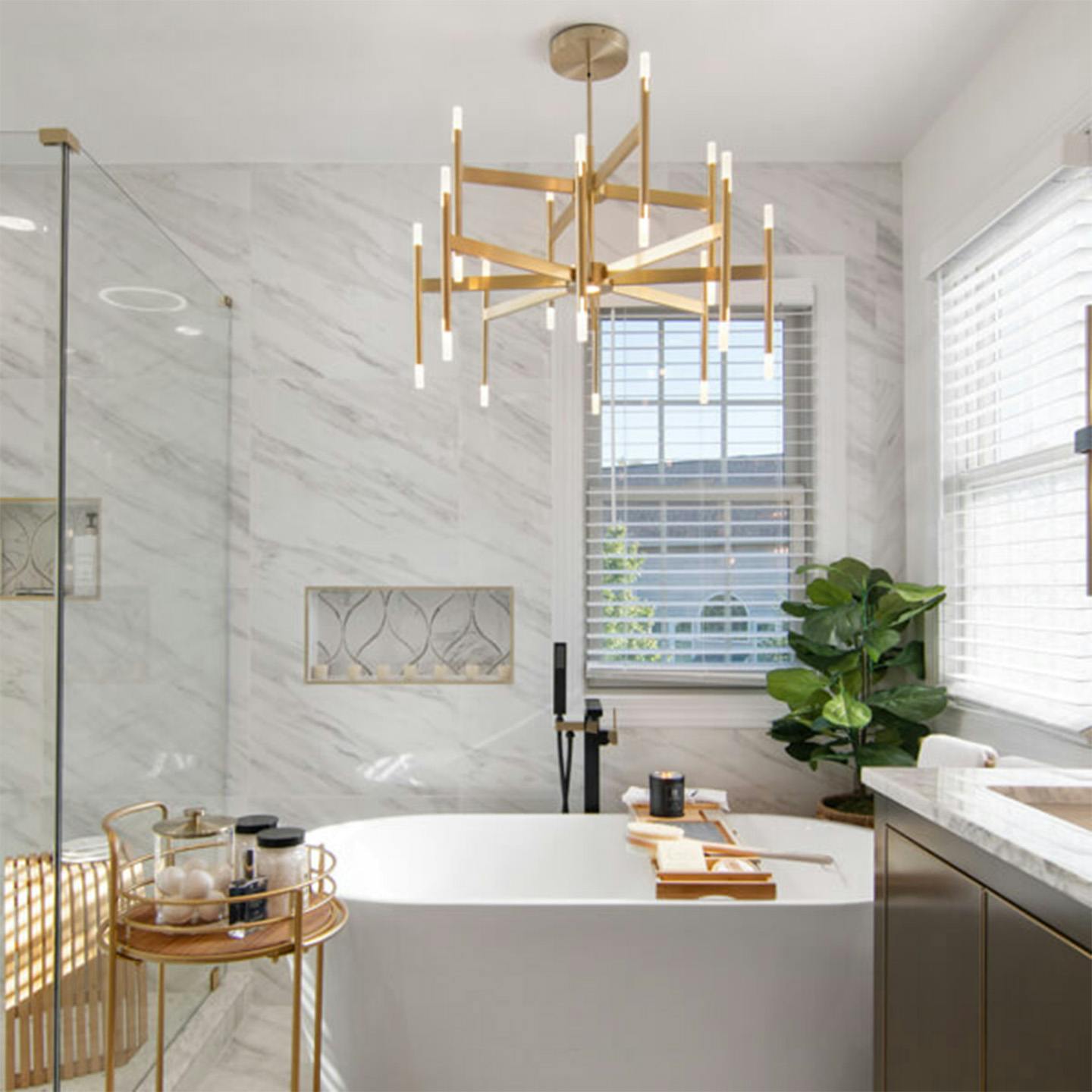 MojisStyle's bathroom tub with chandelier hanging overhead