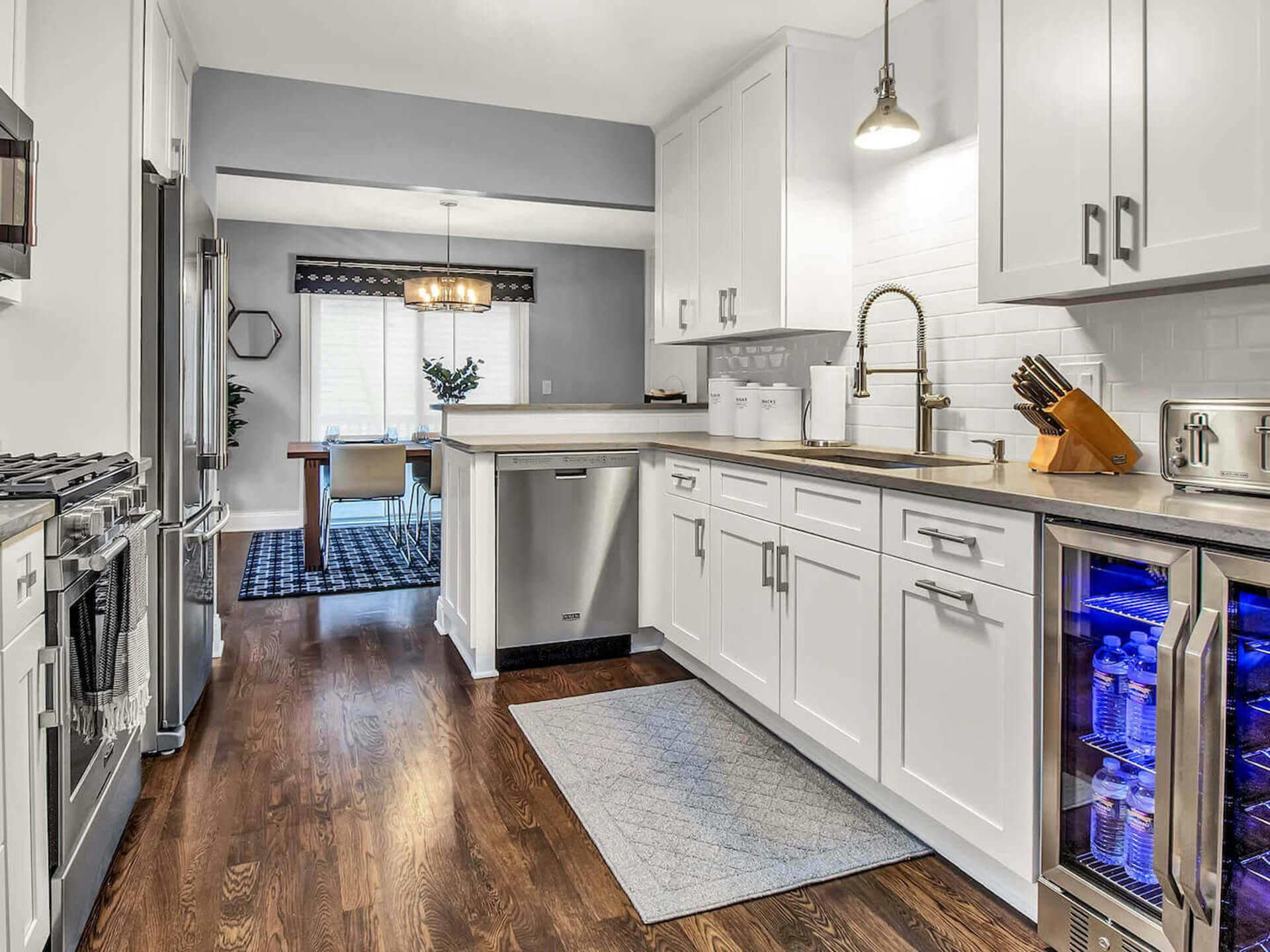 Galley way kitchen with white walls and dark wood floors