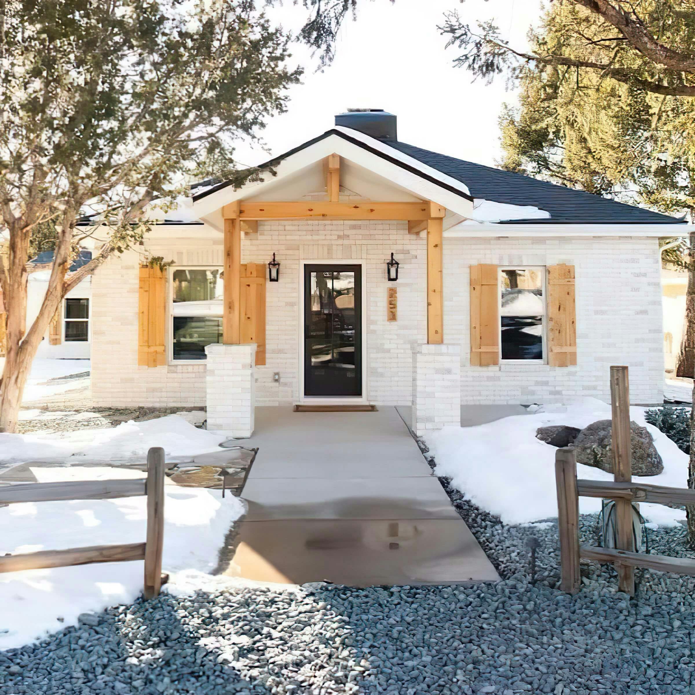 Exterior walkway leading to entrance with Kichler outdoor sconces on either side of the Door