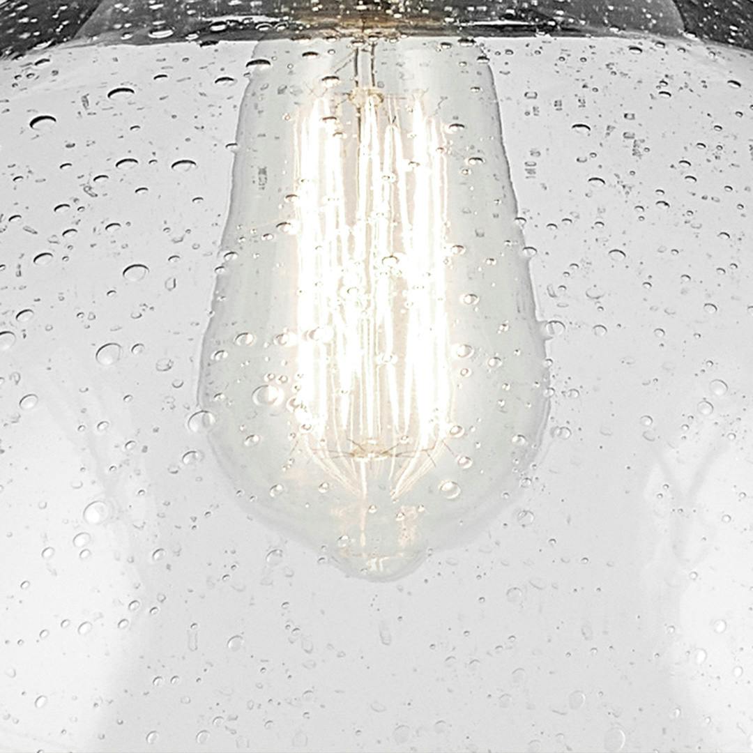 Close up of the Avery 11" 1-Light Dome Pendant with Clear Seeded Glass in Black