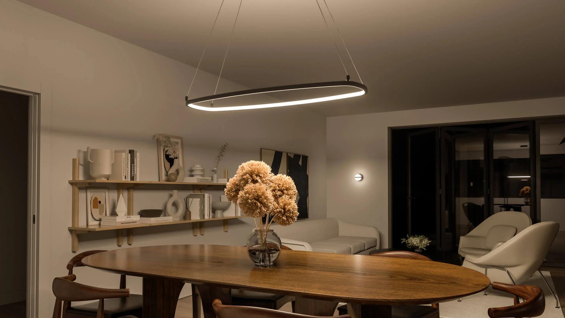 A dining room at night featuring a koloa chandelier over the table.