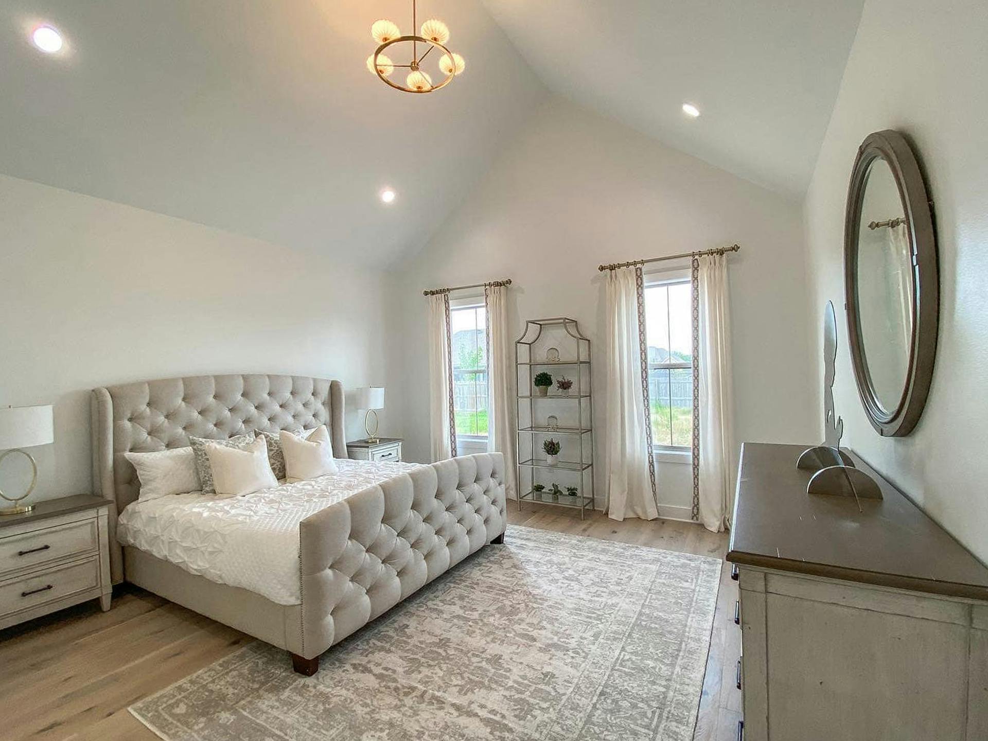 beige themed master with Kichler chandelier hanging from the vaulted ceiling