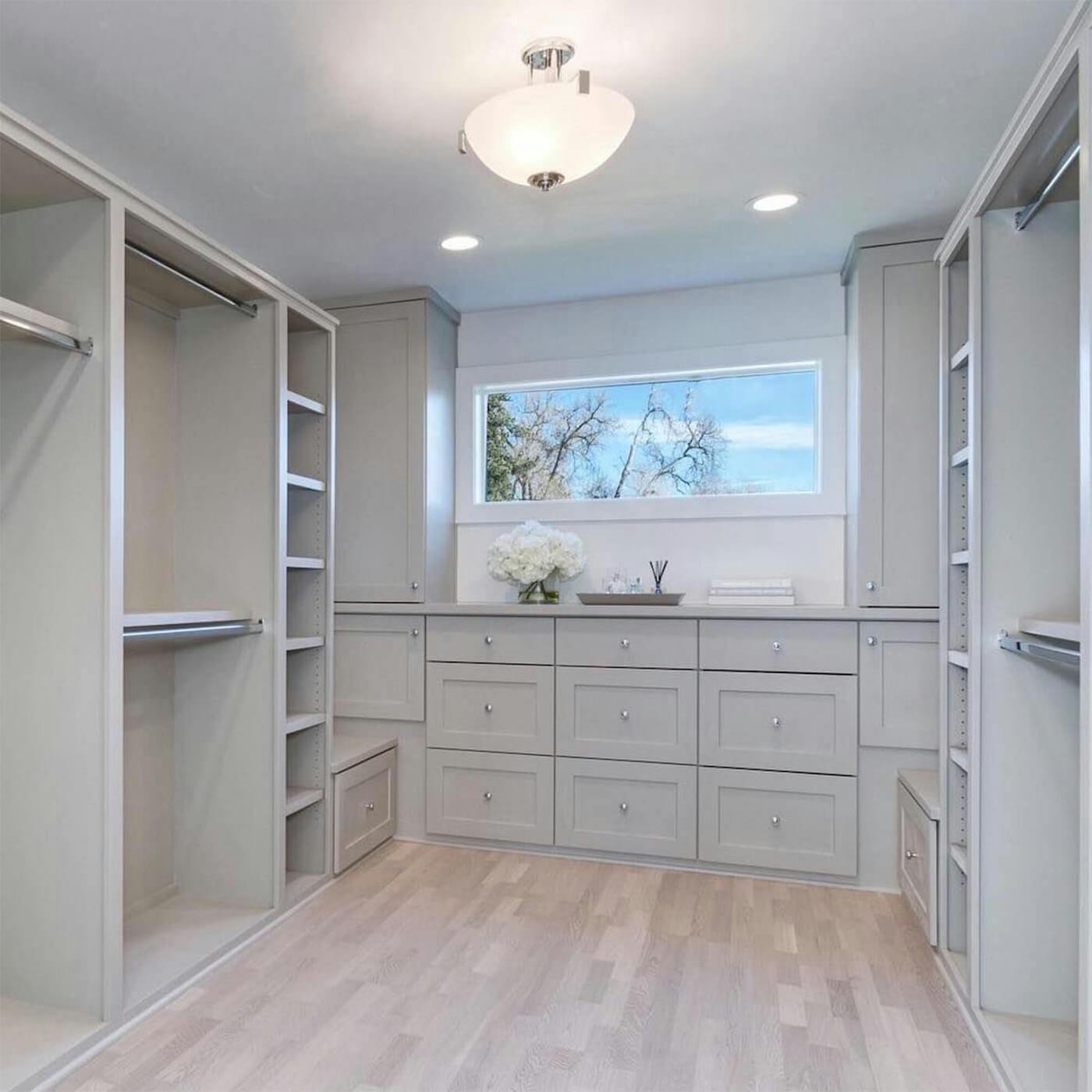 Shadow Creek Homes Instagram post of an empty walk in closet featuring a warm chandelier light